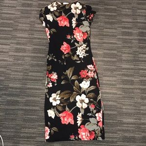 Agaci Dress that is black with cute floral designs